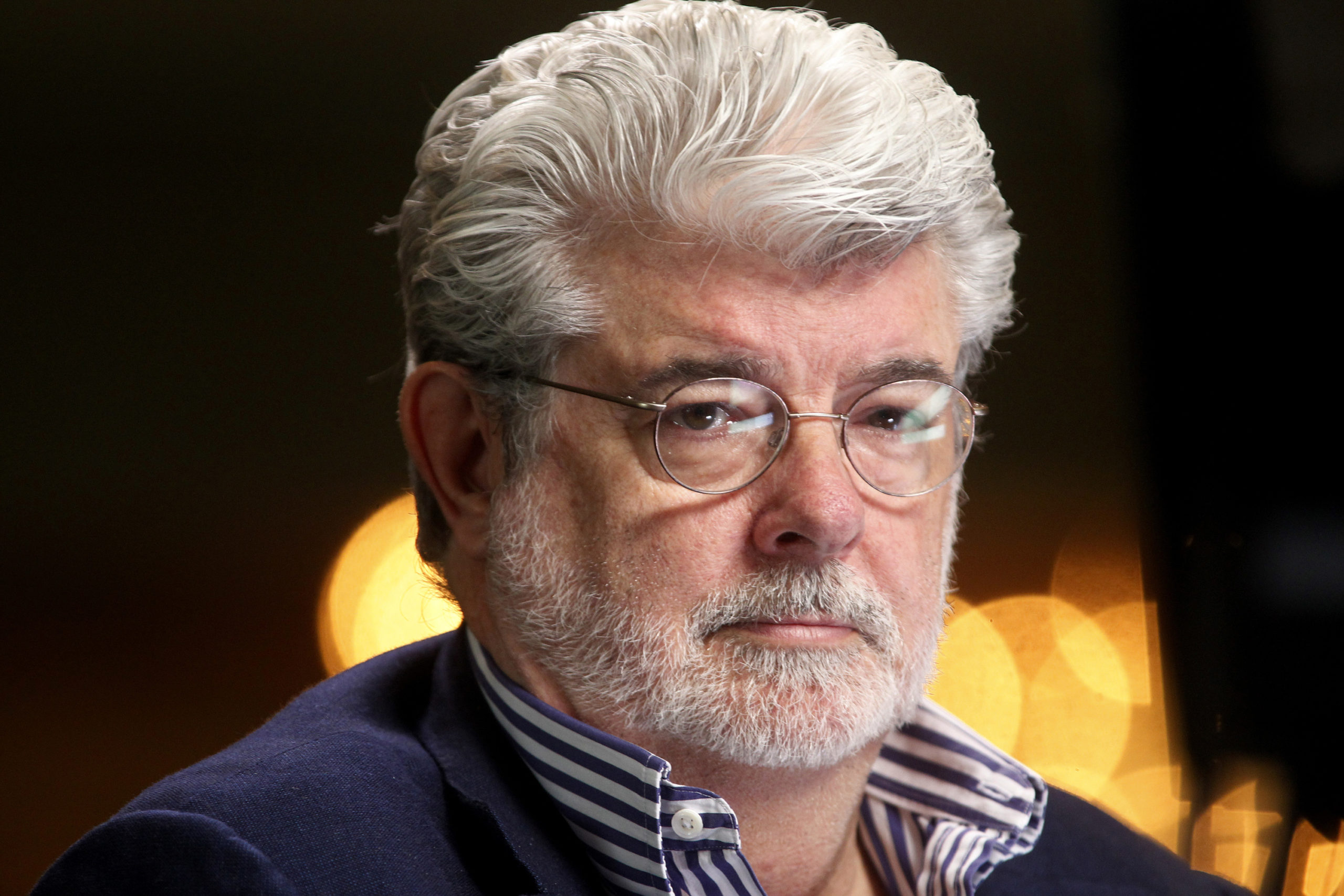 Filmmaker and Chairman of the Board of Lucasfilm Ltd. George Lucas waits to do a television interview at the Milken Institute Global Conference in Beverly Hills, California April 30, 2012. Walt Disney Co said it agreed to buy film maker George Lucas's Lucasfilm Ltd for $4.05 billion, according to news reports on October 30, 2012. Disney will pay about half in cash and issue about 40 million shares at closing for the acquisition of the film studio known for the iconic "Star Wars" movies. Picture taken April 30, 2012. REUTERS/Fred Prouser (UNITED STATES - Tags: BUSINESS ENTERTAINMENT MEDIA HEADSHOT) - RTR39SE4